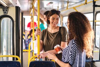 Two ladies riding on the public bus